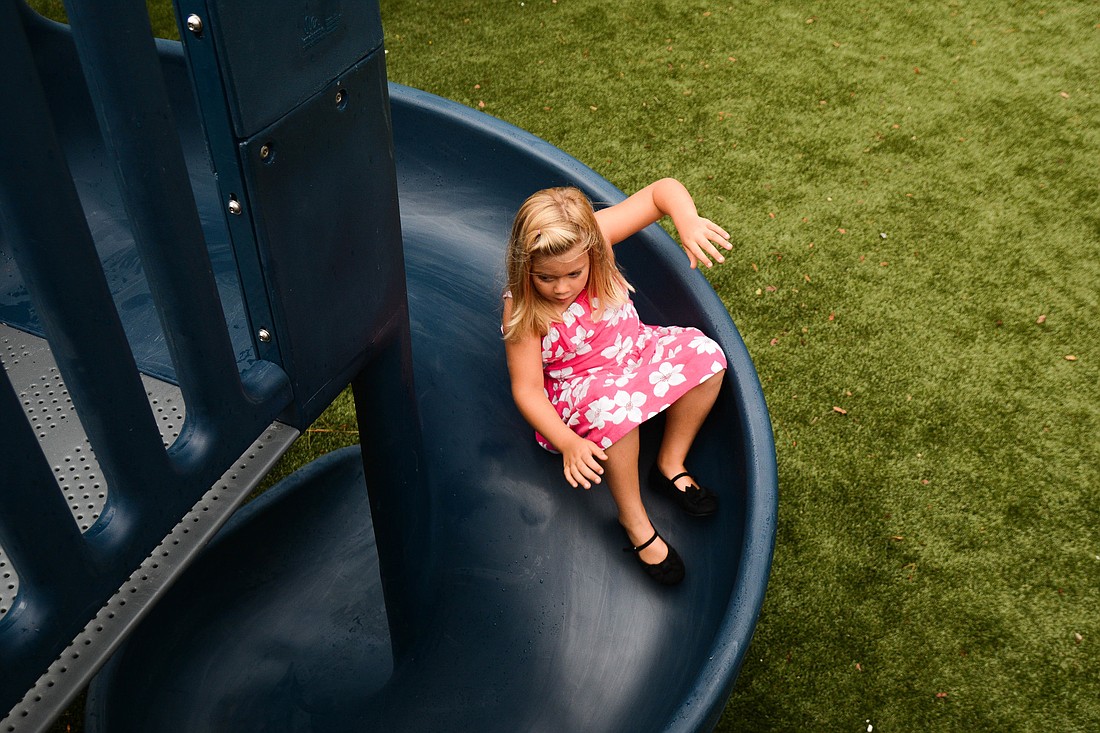 Abby Villarino, 5, tries out the new twisty slide at James F. Holland Memorial Park, where many Palm Coast Parks and Recreation events will take place this fall. Photo by Paige Wilson