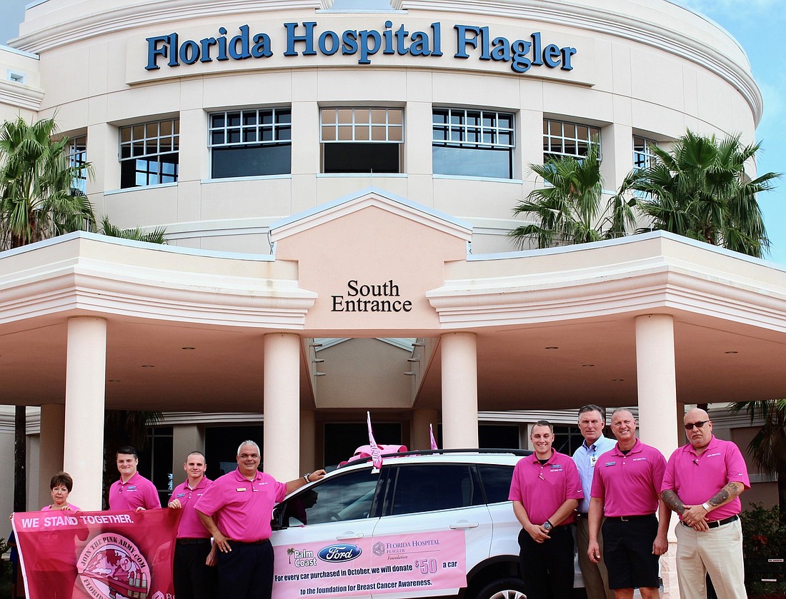 Members of Florida Hospital Flagler and Palm Coast Ford pose in front of FHF in honor of Breast Cancer Awareness Month. Photo by Ray Boone