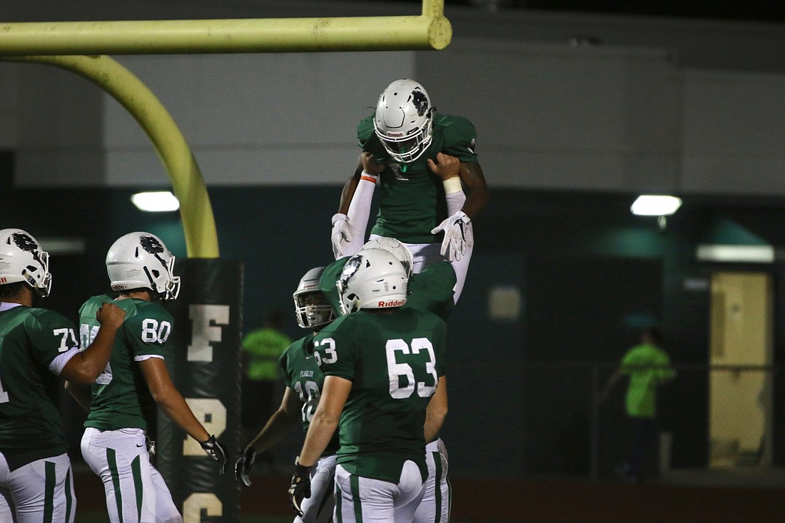 FPC celebrates after a touchdown by running back Jimmie Robinson. Photo by Ray Boone