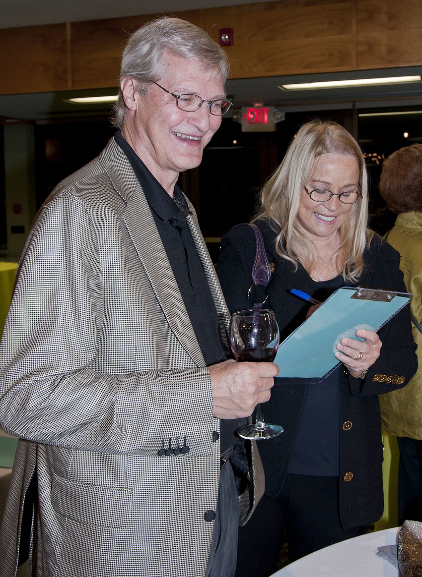 Rick Scott and Zoe Lambros participating in the silent auction