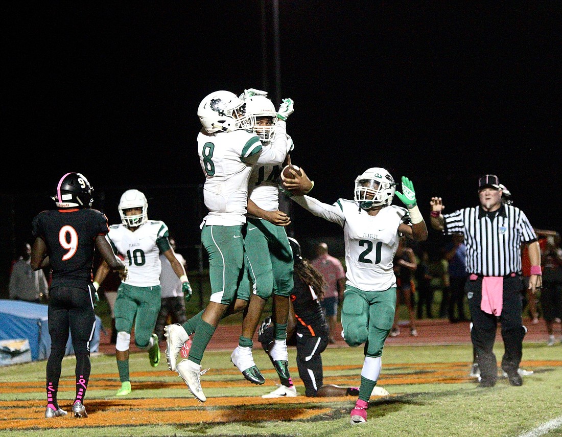 FPC players celebrate after a touchdown against Spruce Creek. Photo by Ray Boone