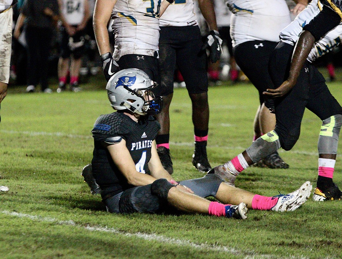 Matanzas running back Josef Powell sits on the ground after being tackled against Pine Ridge. Photo by Ray Boone