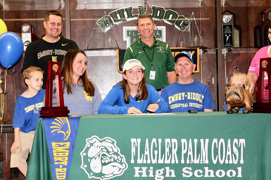 Olivia Whitten with her family after signing her letter of intent to play golf for Embry-Riddle. Photo by Ray Boone