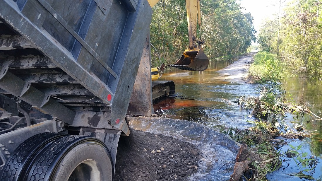 Crews worked to make Wellfield Grade passable after a washout during Hurricane Irma. (Photo courtesy of the city of Palm Coast)