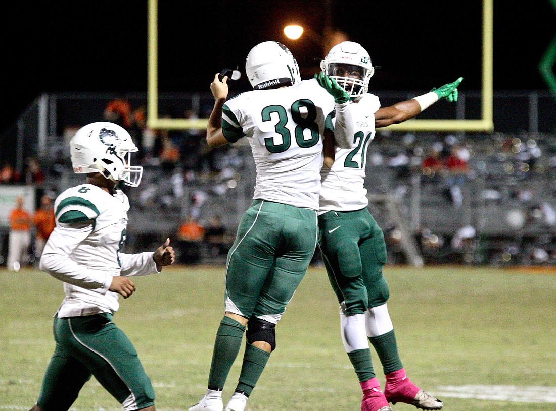 FPC players celebrate after kicker Samuel Petrin (No. 38) knocked through a field goal against Spruce Creek. Photo by Ray Boone