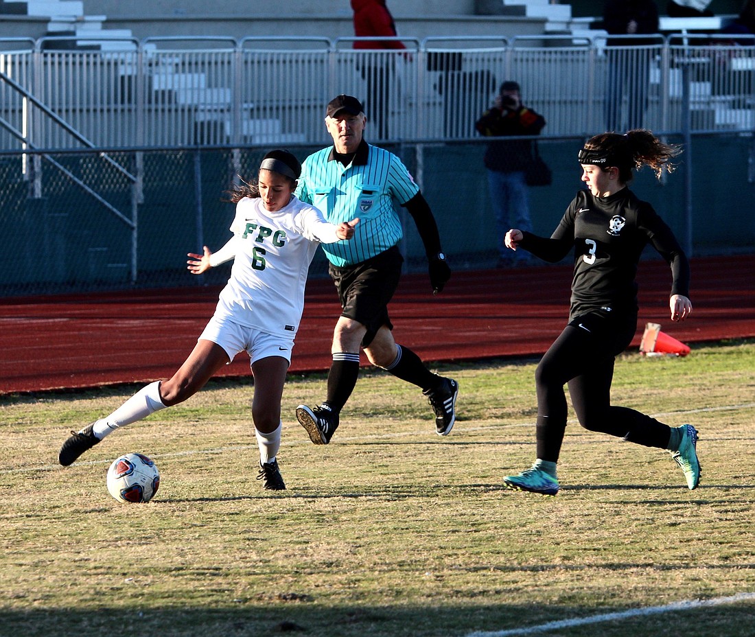 FPC's Ashley Puentes dribbles the ball against a Spruce Creek defender. Photo by Ray Boone