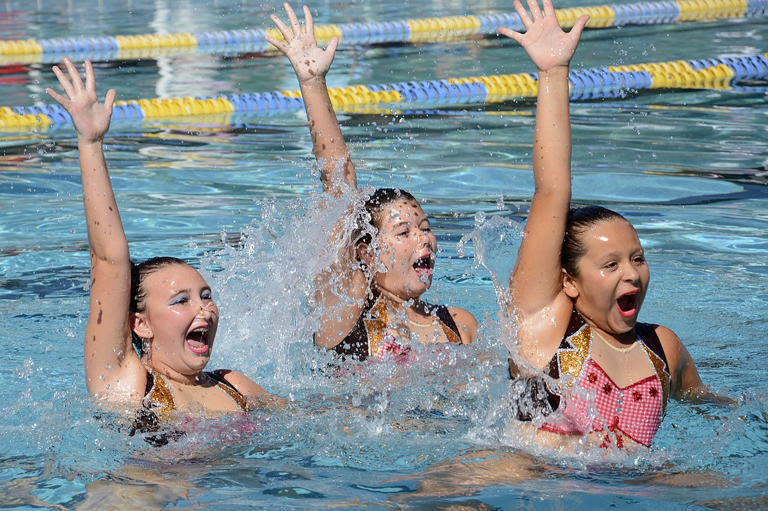 Alex Alvarado, Sarah Morris and Ella Steinwehr perform a synchronized swimming routine during a fundraiser for the Belle Terre Swim and Racquet Club. (File photo by Anastasia Pagello.)