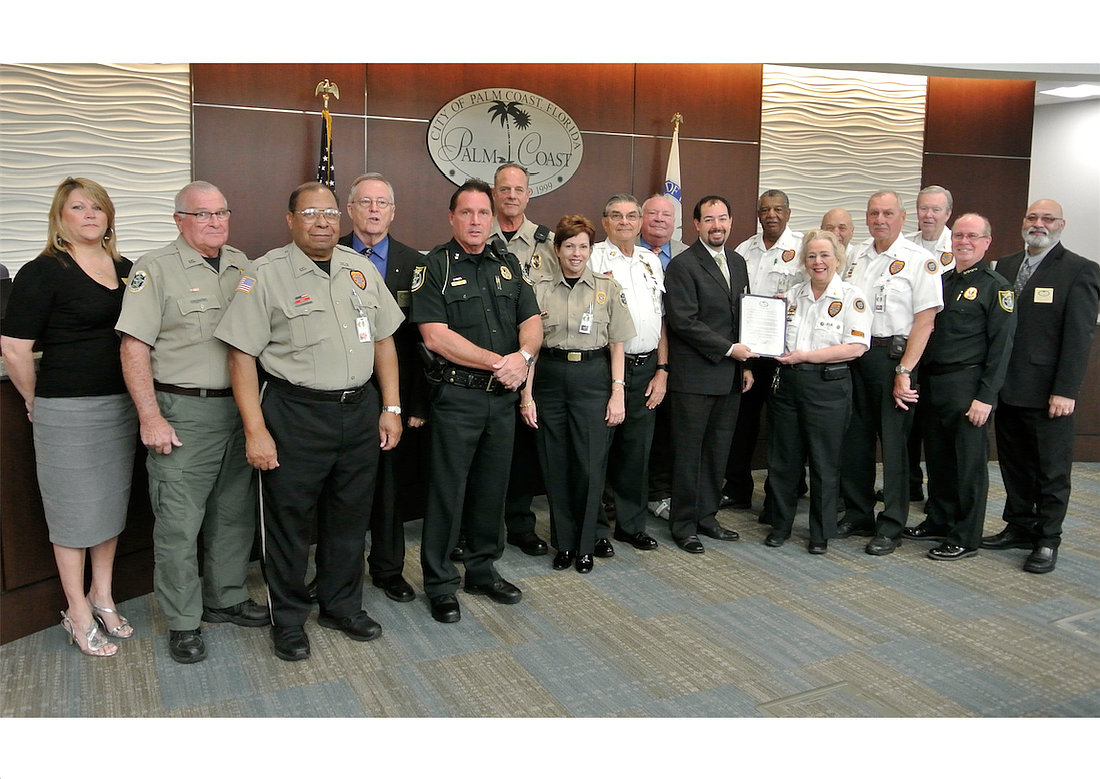The Palm Coast City Council, Sheriff James L. Manfre and Sr. Commander Mark Carman recognized Citizens Observer Program volunteers at a council meeting Feb. 16. (Photo courtesy of the Flagler County Sheriff's Office.)