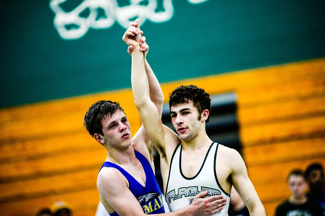 Michael DeAugustino's opponent respectfully lifts his hand in victory. Photos by Bob Rollins