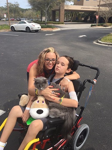 Cameron Higgins enjoys an outside visit with his grandmother's cat Ziggy. Mom, Ashely Higgins can't hug Cameron enough. Courtesy photo