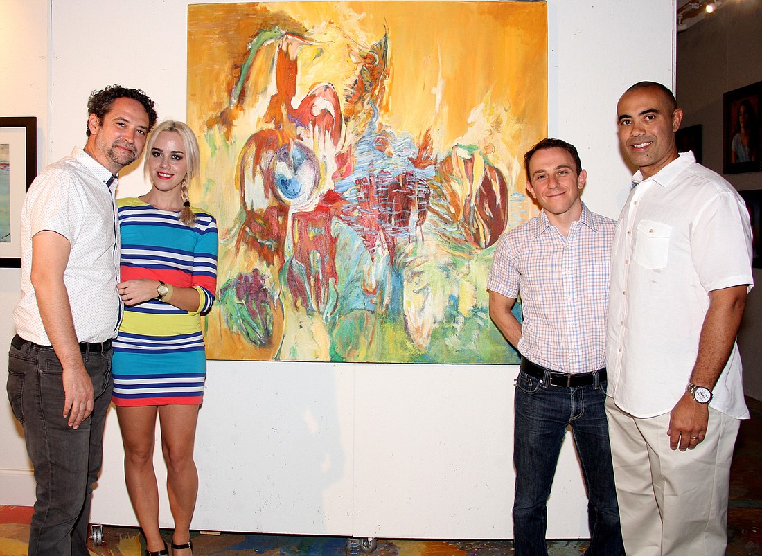 JJ Graham, Petra Iston Ben Solomon, and Ian Solomon stand before one of Linda Solomon's pieces of art on display during a celebration of her life at Salvo Art on Saturday, March 19. Photo by Jacque Estes