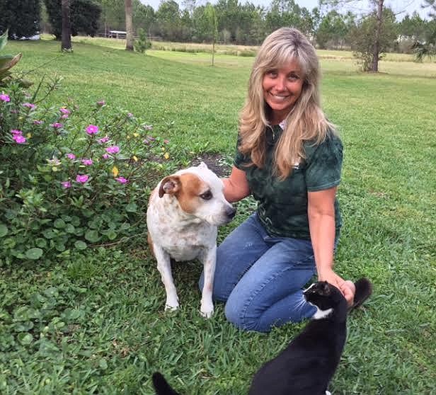 Flagler Humane Society Director Amy Carotenuto, now on the board of directors for the Florida Animal Control Association, plays with her own animals, Opie and Brave Cat.  Courtesy photo