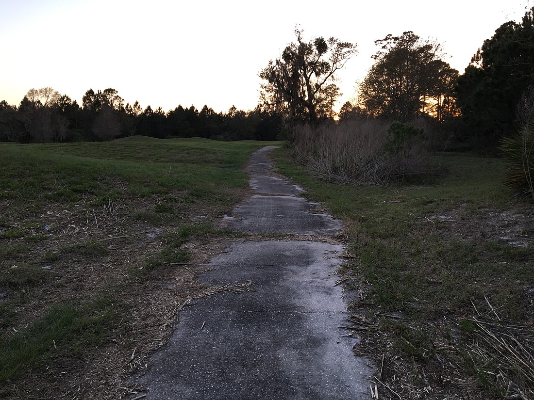The grass has been mowed, but the city says the Matanzas Woods Golf Course property still doesn't meet its standards (Photo by Brian McMillan)