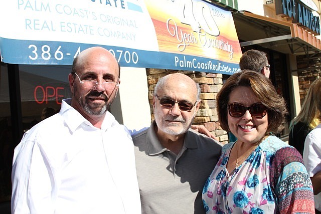 Owner, Chuck Shaffer, and Jose and Edna Levy celebrated Palm Coast Real Estate's 40th Anniversary.