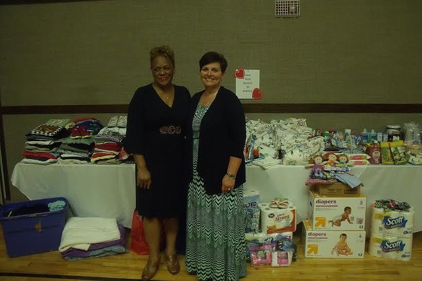 Carolyn Thompkins, president of the Bunnell Relief Society  and Patricia King, service project coordinator, stand in front of the donations made to the Family Life Center. Courtesy photo