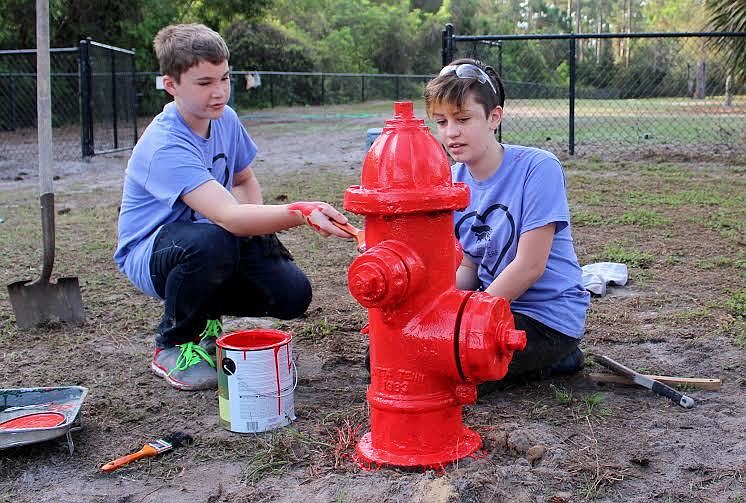 Gabriel Dabboussi and Margaret D'Elia paint a fire hydrant at Wadsworth Dog Park. Courtesy photo