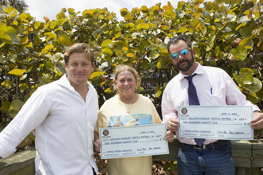 Tortugas owners Scott Fox and Paul Chestnut presented Turtle Fest founder, Lori Ottlein with a $225 donation check. Tortugas will donate $1 for every Terrapin Hopsecutioner beer they sell the rest of the year.