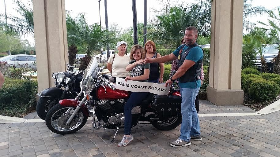 Jeanette Loftus sits on her new motorcylcle as husband. Standing next to her is Chris Hall, the incoming Palm Coast Rotary president, Mary Stetler, Linda Aurora, and (blocked) Sally Thyer. Courtesy photo