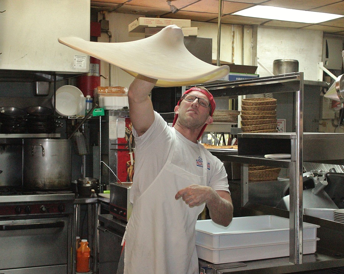 Alex Stephens shows off some of dough boy moves at Joe's New York Pizza. Photo by Jeff Dawsey