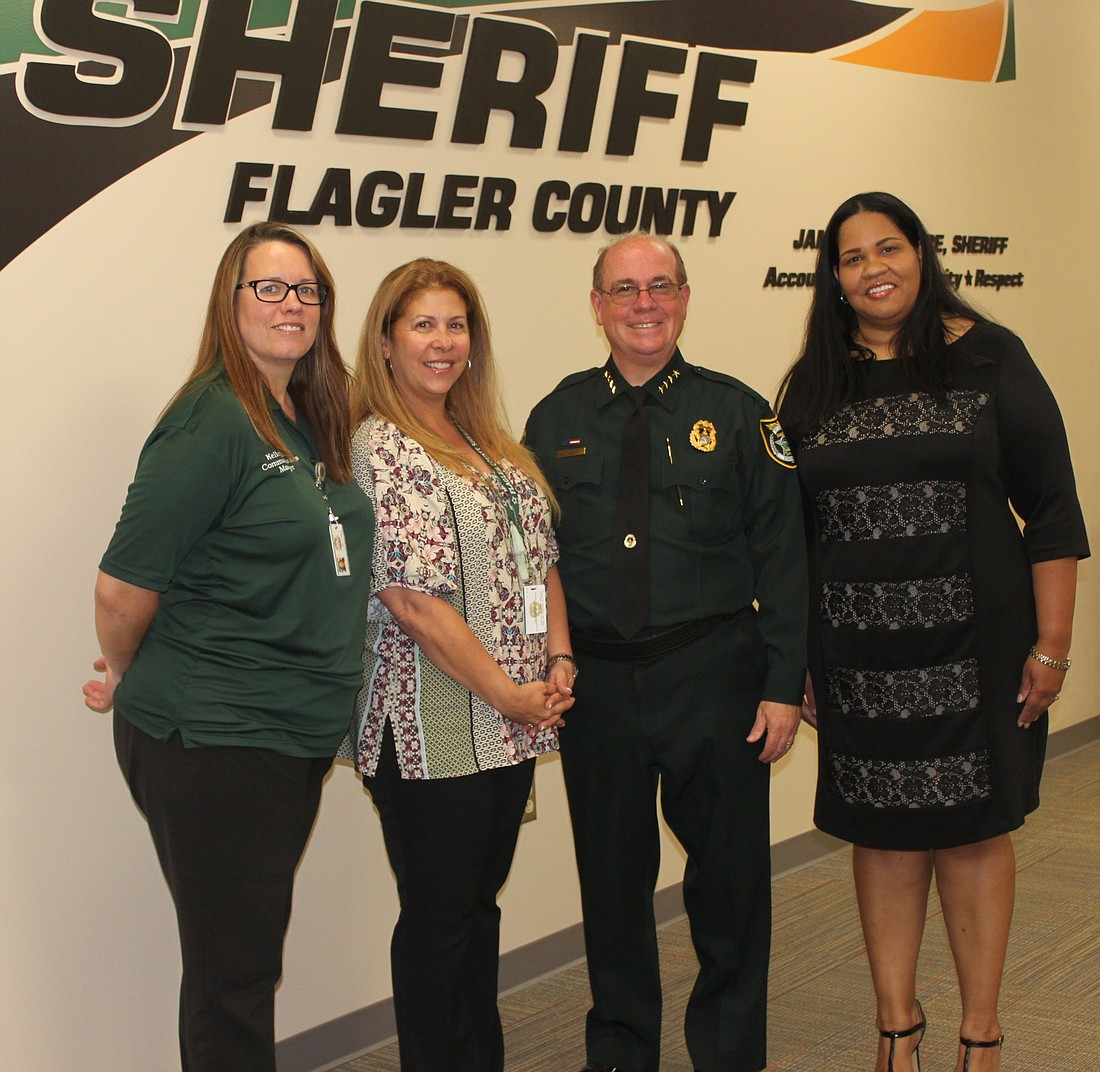 Communications Manager Kelley Eisen,  Communications Specialist Iris Sciandra, Sheriff James L. Manfre and Communications Specialist VeEtta Bess-Dukes (Photo courtesy of the Flagler County Sheriff's Office)