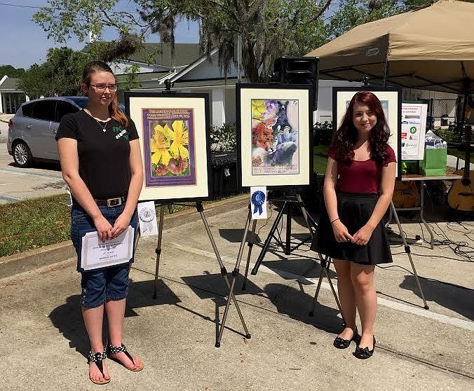 Marissa Gates and Saralyn Cieri pose for photos in front of their winner poster entries at the Garden Club of Palm Coast Expo on Saturday. Not pictured,  Alex Airyy. Courtesy photo
