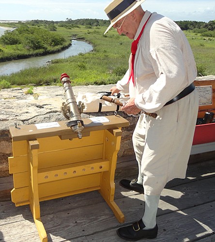 A Fort Matanzas volunteer  shows off an 18th-century swivel gun.