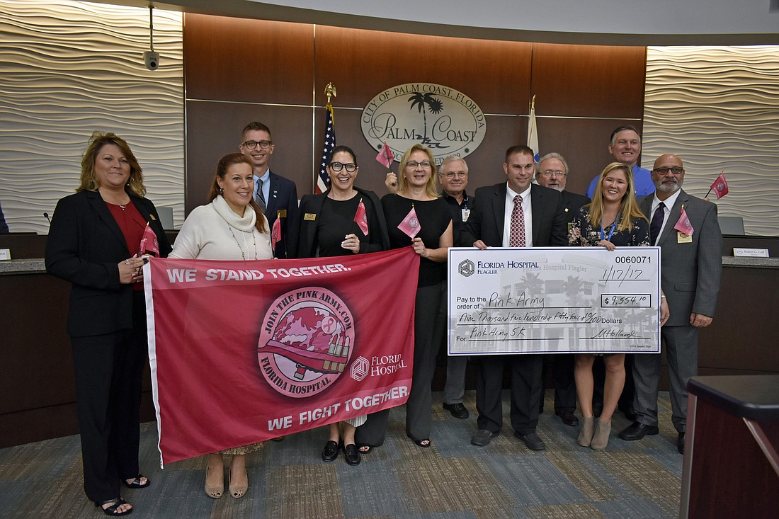 Palm Coast Council Members and Parks and Recreation staff present the check to representatives of Florida Hospital Flagler Foundation. (Courtesy photo)