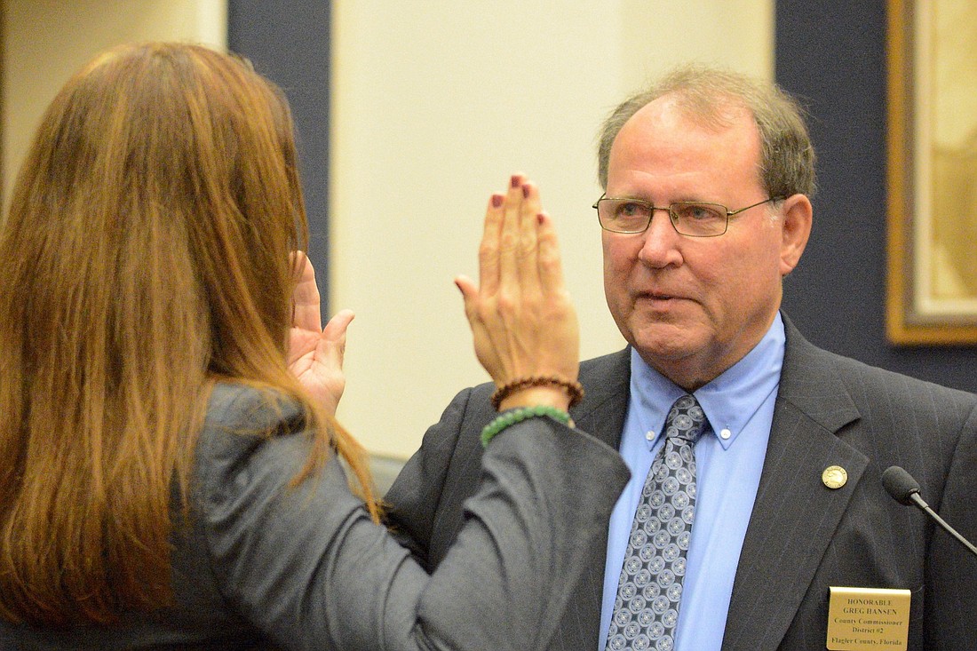 Gregory Hansen takes the oath of office for the County Commission District 2 seat. The oath was administered by County Judge Melissa Moore Stens. (Photos by Jonathan Simmons)