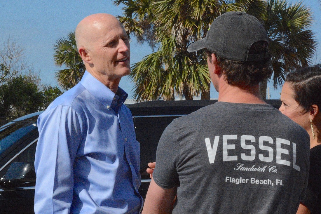 Gov. Rick Scott speaks with Vessel Sandwich Co. co-owners Ben Kirk and Haley Kirk. Photo by Jonathan Simmons