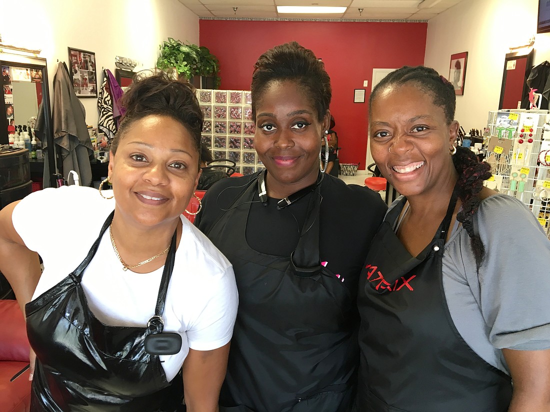 2 of a Kind Hair Studio owners Valarie Roberts and Tisa Riles pose with stylist Danielle Keith. (Photo by Brian McMillan)