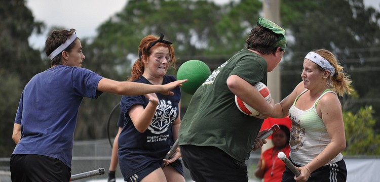 Students at the Ringling College of Art and Design and the University of South Florida fight for the ball.
