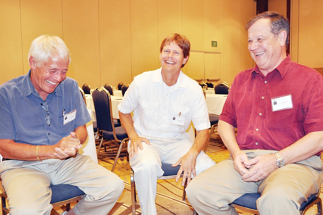 Don Bruns, Ward Larsen and H. Terrell Griffin joke around at the Mystery Mingle.