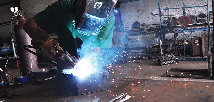 Welder Bob Bauman, of All Phases Welding & Fabrication, works on a floor joist bracket. Bauman has been welding for 23 years â€” even performing the job while serving in the U.S. Navy.