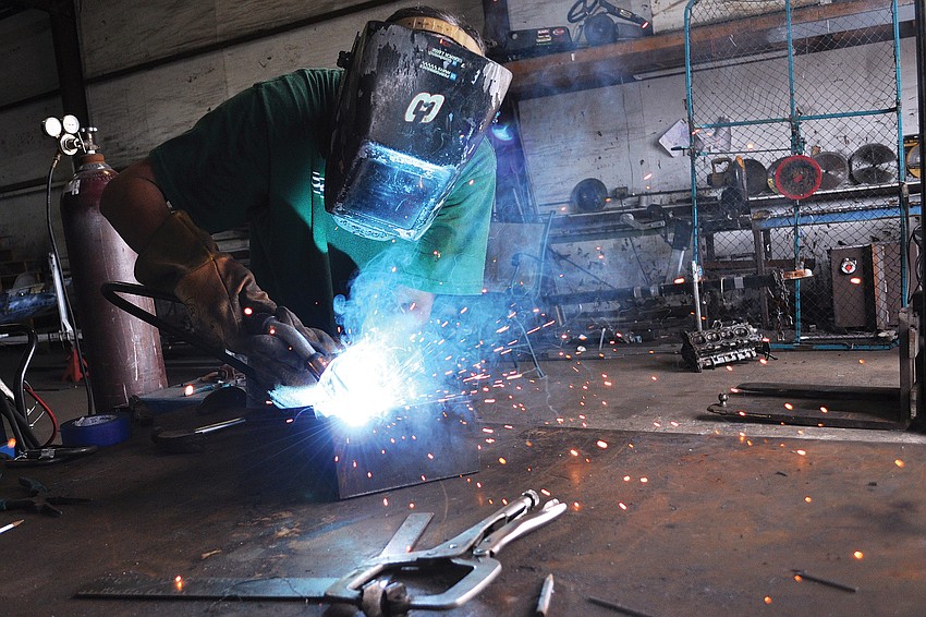 Welder Bob Bauman, of All Phases Welding & Fabrication, works on a floor joist bracket. Bauman has been welding for 23 years â€” even performing the job while serving in the U.S. Navy.