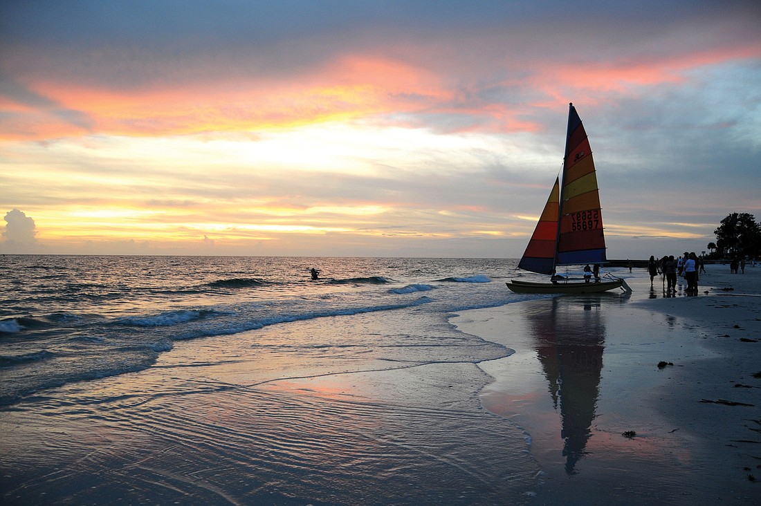 Rebecca Wild Baxter took this photo of friends preparing for a late-evening sail at Siesta Beach.