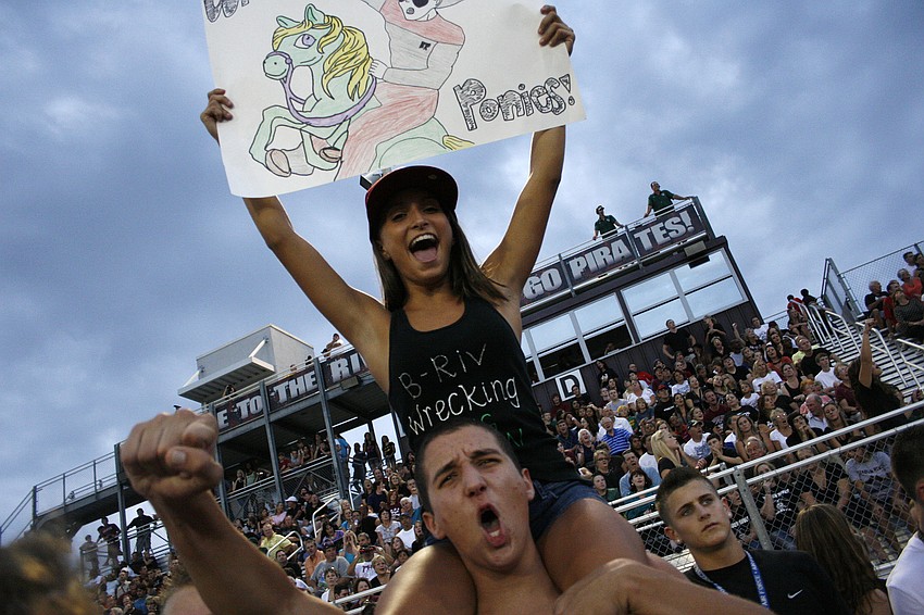 Sarah Kinsey got a boost from a classmate so she could cheer on the Pirates from above.