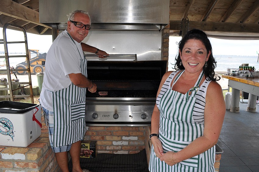 Peter Easton and Jami Heredia pose before taking over the grill for their shift Saturday, Sept. 3 at the 65th Labor Day Regatta at the Sarasota Sailing Squadron.