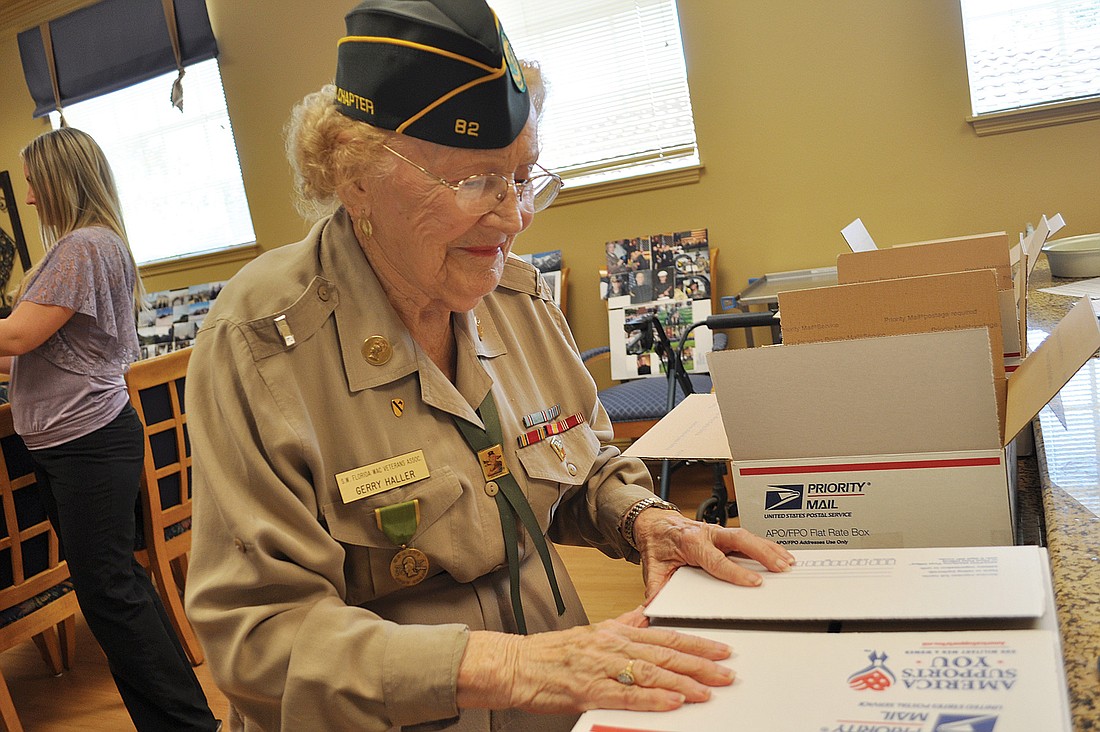 The Windsor resident Gerry Haller wore a replica of her old military uniform as she packed care boxes for her grandson.