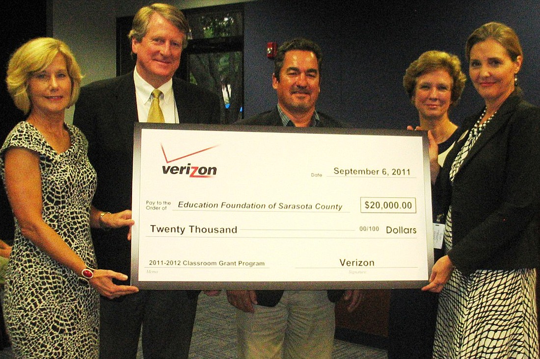 The check marks an increase in donations from the Verizon Foundation to the Education Foundation.
