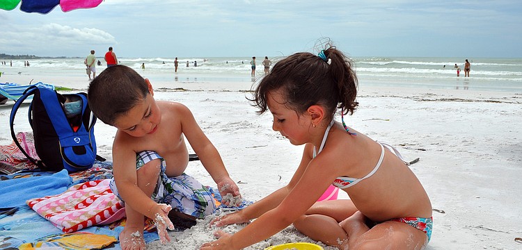 Oscar, 2 1/2, and Emilia, 4 1/2, Estrada work on making sand castles Wednesday, Sept. 7 on Siesta Key beach. The Estrada family, from Bolivia, is on a 2-week family vacation.
