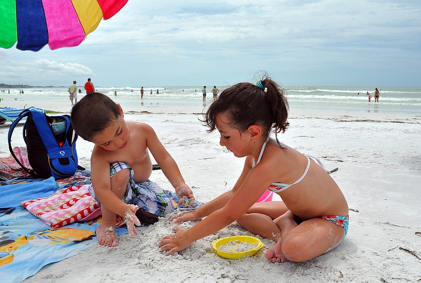 Oscar, 2 1/2, and Emilia, 4 1/2, Estrada work on making sand castles Wednesday, Sept. 7 on Siesta Key beach. The Estrada family, from Bolivia, is on a 2-week family vacation.