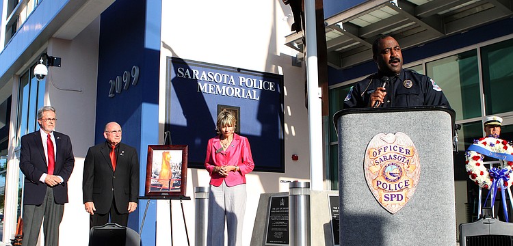 Commissioner Joe Barbetta, Norm Schimmel and Mayor Susan Atwell stand back while Chief Mikel T. Hollaway speaks to the crowd.