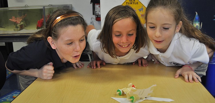 Gillette Bauer, Susan Pacer and Sofia Mascorro send their Life Savers race car zooming across a table.