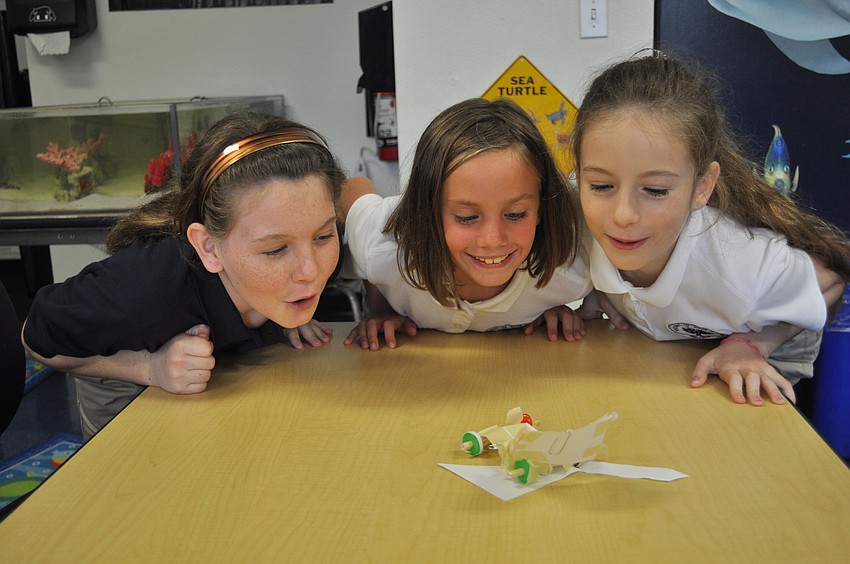 Gillette Bauer, Susan Pacer and Sofia Mascorro send their Life Savers race car zooming across a table.