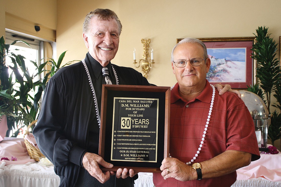 Casa del Mar Board of Directors President John Zefeldt recognizes D.M. WilliamsÃ¢â‚¬â„¢ service with a plaque Saturday, at the Helmsley Sandcastle Hotel.