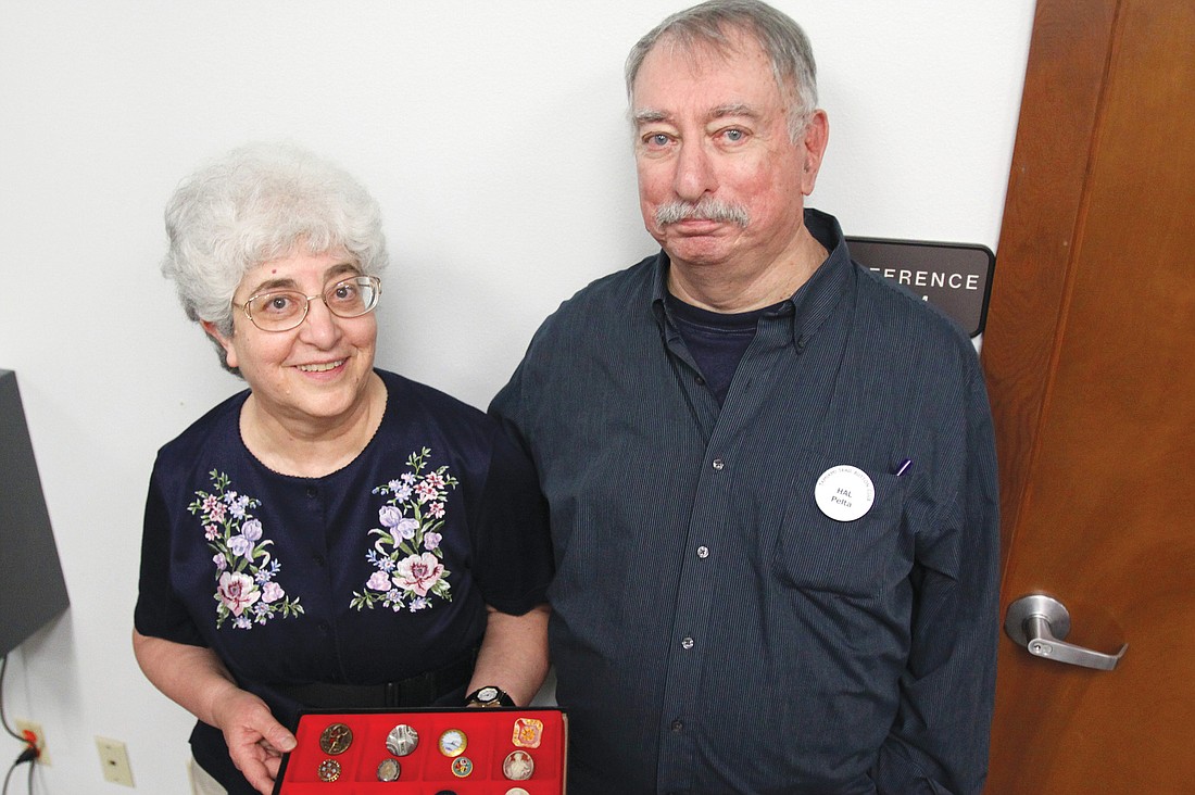 Helen and Hal Pelta show a tray of buttons that contain Helen Pelta's favorite buttons in her collection.