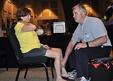Owen Marron of the Center of Integrated Medicine performs acupressure on Windmill Manor resident Ann Carb