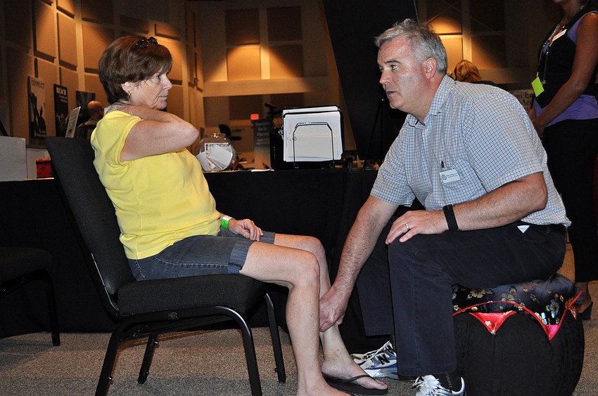 Owen Marron of the Center of Integrated Medicine performs acupressure on Windmill Manor resident Ann Carb