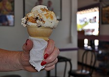 Karen Abraham holds her ice cream cone of Big Olaf's vanilla with brownies and a caramel swirl.