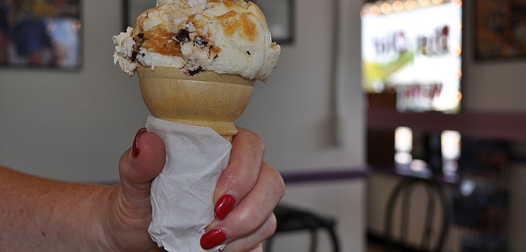 Karen Abraham holds her ice cream cone of Big Olaf's vanilla with brownies and a caramel swirl.